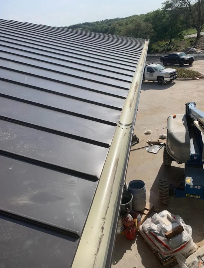 Standing seam panel and gutter detail on a metal roofing jobsite in Conemaugh